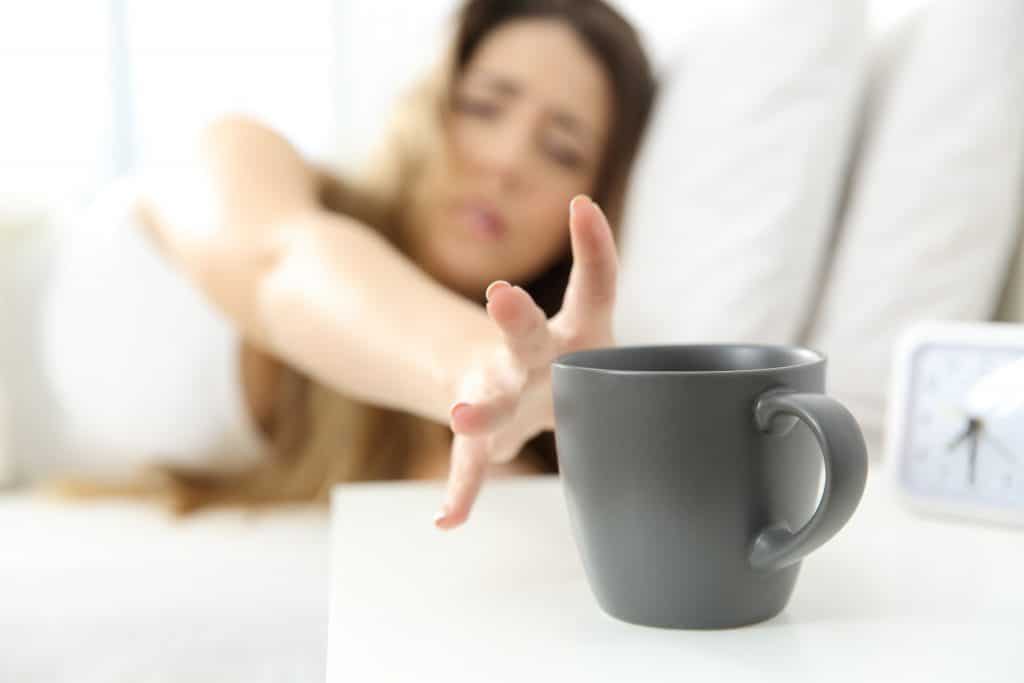 Woman waking up needing coffee